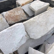 White sandstone random loose stone wall corner